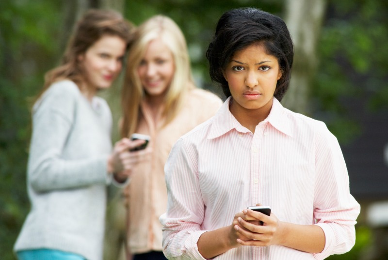 Teenage Girl Being Bullied By Text Message On Mobile Phone